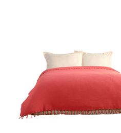 a red bed with two pillows on top of it