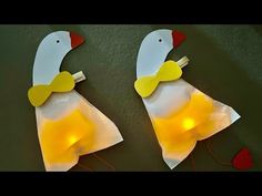 two pieces of paper that have been made to look like ducks with lights on them