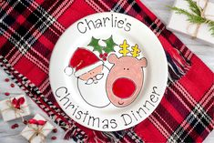 a christmas dinner plate with an image of a reindeer and santa clause on the side