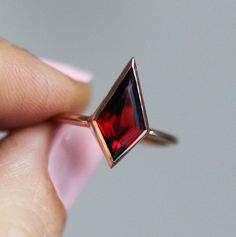 Red garnet ring with a large kite shaped geometric garnet gemstone.
Main stone: kite shaped natural red garnet step cut
Measurements: approx. 12x7mm Setting: bezel Unique Garnet Ring, Red Engagement Ring, Kite Ring, Jewelry Necklace Simple, Garnet Engagement Ring, Red Garnet Ring, Engagement Ring Unique, Magical Jewelry, Step Cut