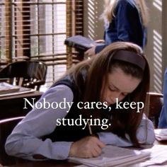 a woman sitting at a desk writing in front of a book with the caption nobody cares, keep studying