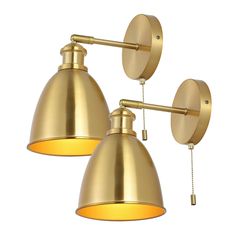 two brass colored lights are hanging from the wall, one is turned on and the other is off