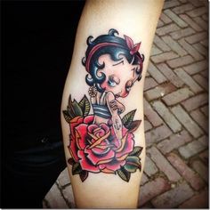 a girl with a rose tattoo on her arm