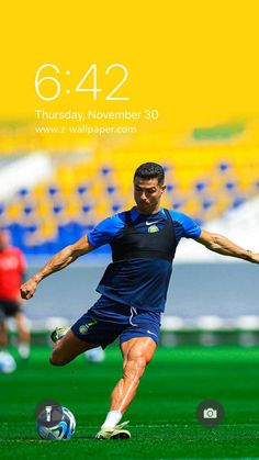 a man kicking a soccer ball on top of a field