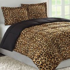 a leopard print comforter set on a bed