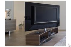 a flat screen tv sitting on top of a wooden entertainment center in a living room