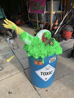 a trash can that has some green stuff in it