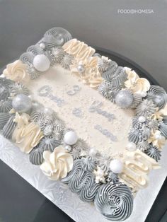 a cake decorated with silver and white decorations