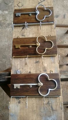 four wooden key holders with metal keys attached to them