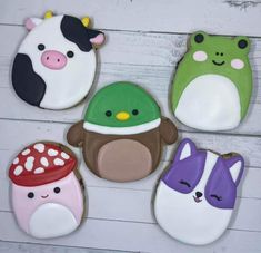 four decorated cookies in the shape of animals