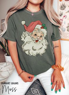 Merry Christmas Santa Shirts For Women, Retro Santa T-Shirt, Groovy Holiday Winter Christmas Snowman Tshirt, Vintage Xmas Comfort Colors Tee HOW TO ORDER ➀ Select color ➁ Select the size (Please check size chart) ✦ True to size. Size up 1-2 sizes for an oversized look. ➂ Add to cart ✦ (Optional) "Add message to Seller" on the checkout page. GARMENT FEATURES ✦ Crew neckline ✦ Direct to garment printing - no vinyl, decal, or iron-on technique ✦ Our designs are printed on the garment to last a long time and may not appear as 'glossy' or saturated as iron-on designs are. ✦ Please note that colors may appear different on different digital screens and may not be a true representation of the actual colors. ✦ Additional T-Shirt Colors and Sizes Available Upon Request ✧✧Brands: Bella Canvas Unisex Holiday Letter Print Short Sleeve Tops, Holiday Tops With Funny Print And Short Sleeves, Funny Print Short Sleeve Holiday Top, Christmas Letter Print Short Sleeve Tops, Holiday Graphic Tee With Crew Neck, Holiday Funny Print Short Sleeve Top, Green Short Sleeve Christmas Tops, Holiday Graphic Tee With Short Sleeves, Green Short Sleeve Holiday Top