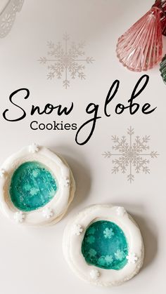 two snow globe cookies sitting on top of a table