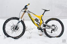 a yellow and black mountain bike in the snow