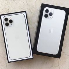 two new iphones are in the box, one is white and the other is black