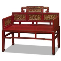 a red bench with gold designs on it's back and sides, against a white background