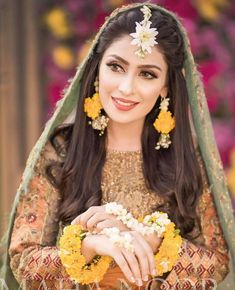 a woman in a bridal outfit with flowers on her head