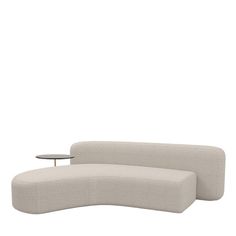 the curved sofa is next to a table