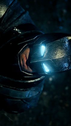 the iron man armor is glowing brightly in the dark, while his hands are visible