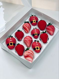 a box filled with chocolate covered strawberries in the shape of santa's hat