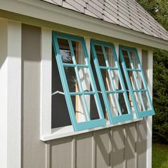 a blue window on the side of a house