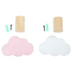 three wooden pegs and two plastic clouds on a white background