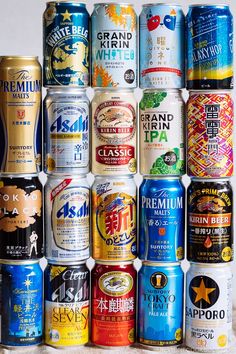 many different types of beer cans stacked on top of each other