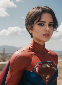 a woman in a superman costume posing for the camera