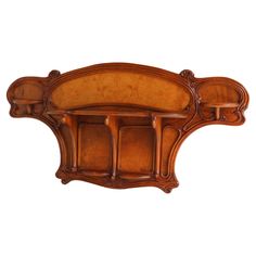 an ornate wooden headboard with carved details on the top and bottom, against a white background