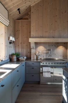 a kitchen with wood paneling and stainless steel appliances