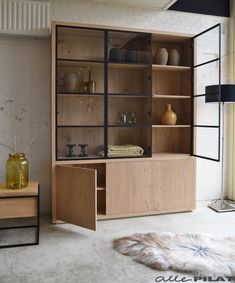 a wooden cabinet with glass doors in a living room