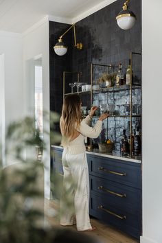 a woman standing in front of a bar