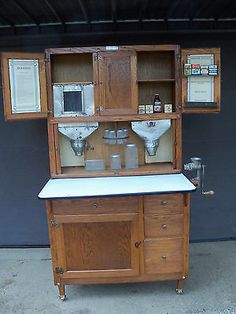 an old fashioned wooden cabinet with glass doors