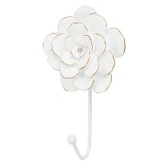 a white and gold flower on a hook