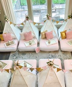 several pink and white tents with gold accents