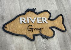 a wooden sign that says river gry on the side of a wood plank floor