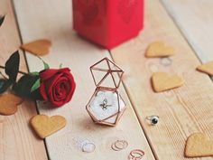 a rose and some hearts on a table