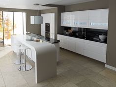 a modern kitchen with white cabinets and black counter tops, along with an island in the middle