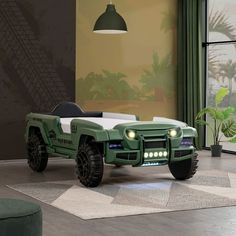 a green car is parked in the middle of a living room with a large window