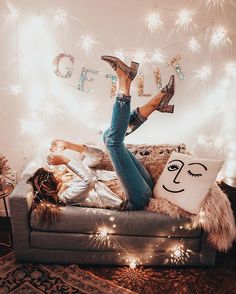 a woman laying on top of a couch with her legs up and shoes in the air