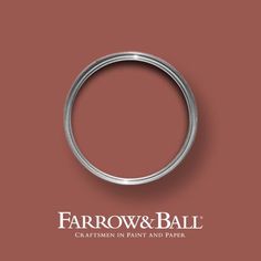 a ring with the words farrow and ball written in white on it, against a red background