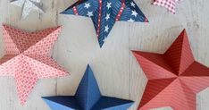 five red, white and blue paper stars on a table