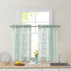 a kitchen with a sink, counter top and window in front of the windowsill