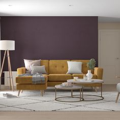 a living room with purple walls and furniture