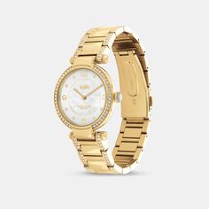 Timeless and elegant the Cary watch is a sophisticated style perfect for day or night. The gold tone bracelet design shimmers with crystals and features a luminous mother-of-pearl dial with our iconic Horse and Carriage motif for a heritage touch. | Coach Cary Watch, 34 Mm - Women's - Gold Elegant Gold-tone Watch With Round Dial, Timeless Gold-tone Formal Watch, Classic Gold Coach Watch, Elegant Coach Jewelry With Polished Finish, Gold Coach Watch With Metal Dial, Classic Gold-tone Watch With Round Dial, Coach Gold Watches With Metal Dial, Coach Gold Watch With Metal Dial, Luxury Coach Watches With Diamond Hour Markers