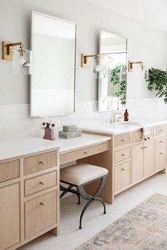 a large bathroom with two sinks and mirrors