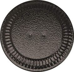 a black plastic plate with holes in the middle and water droplets on it's surface