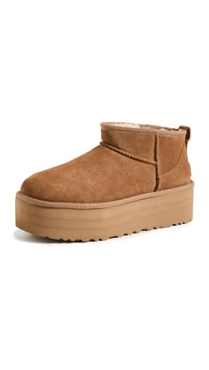 PRICES MAY VARY. Suede upper 17mm UGGplush wool lining 17mm UGGplush wool insole SugarSole EVA outsole 2" platform height Cute Uggs, Ugg Ultra Mini, Ugg Store, Preppy Shoes, Ugg Classic Ultra Mini, Ugg Mini, Preppy Fall, Shoe Wishlist, Shoe Inspo