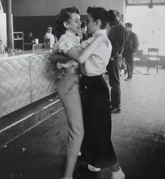 an old photo of two women dancing together