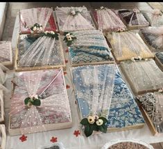 there are many different types of fabric on display at the market table with flowers and ribbons