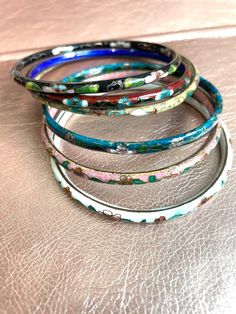 A beautiful selection of cloisonné bangles!  All bangles are sold separately!  these are all Vintage and some are even antique so they have natural science of wear.  please see attached pictures for sizing on each bangle.  these Bengals are well-made, but banging them against something very hard could cause them to break.  as with most vintage items, they should not be worn while doing very active activities like running jogging, working out swimming or any athletics as well as cooking, like sli Traditional Handmade Enamel Bangle, Traditional Hand Painted Bangle Bracelet, Multicolor Enamel Bangle Bracelets, Vintage Multicolor Enamel Bangle, Traditional Multicolor Enamel Bracelets, Multicolor Hand Painted Bangle, Hand Painted Multicolor Bangle, Bangles Aesthetic, Active Activities